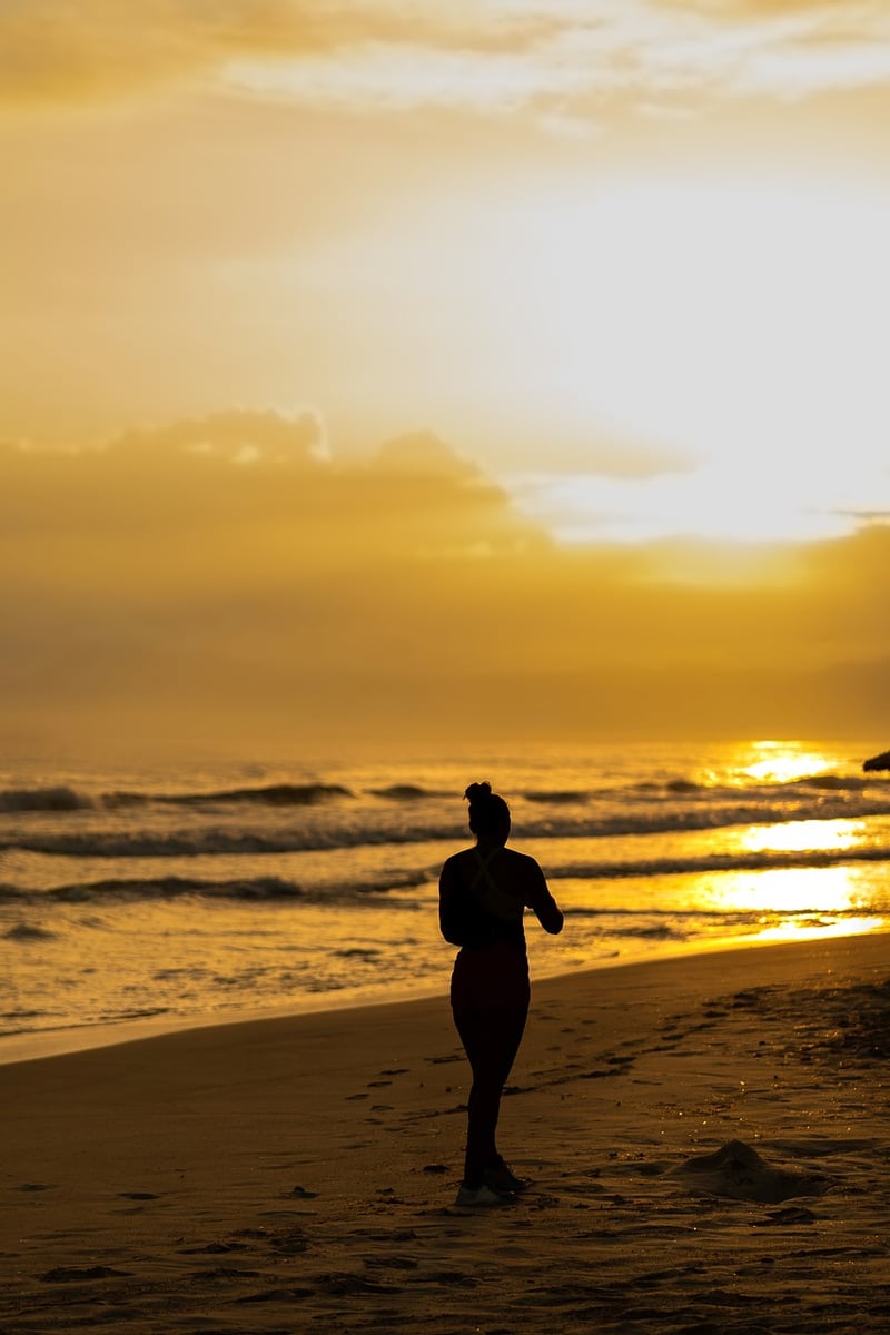 Woman Walking on Beach at Sunset